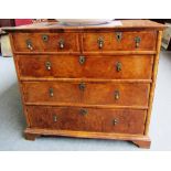 A Queen Anne and later figured walnut chest of two short and three long graduated drawers,