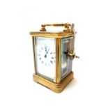 A gilt brass cased carriage clock, early 20th century, the white enamel dial detailed J. W.