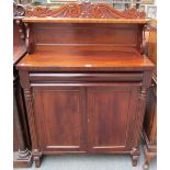 An early 19th century mahogany chiffonier with ledge back,