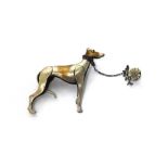 A silver brooch designed as the standing model of a greyhound,