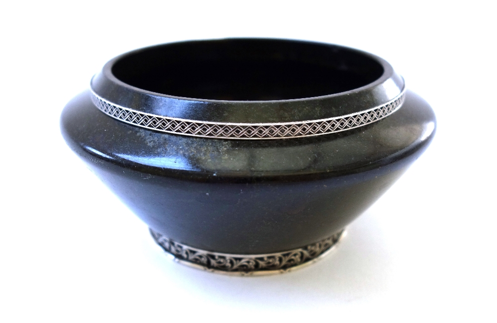 A hardstone circular bowl, 20th century, with applied white metal mounts,