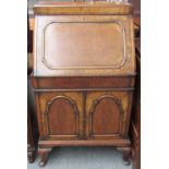 A 20th century figured walnut drinks cabinet in the form of a Queen Anne style bureau, 70cm wide.