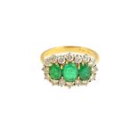 An 18ct gold, emerald and diamond set ring,