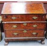 An early 18th century figured walnut two section bureau,