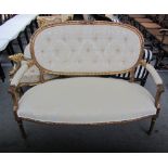 A Louis XVI style gilt framed open arm sofa, on tapering fluted supports, 127cm wide.