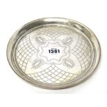 A silver circular small tray, with engraved decoration, diameter 19.