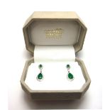 A pair of white gold, emerald and diamond set pendant earrings,