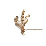 A gold and seed pearl set brooch, designed as a floral and foliate spray, detailed 15ct,