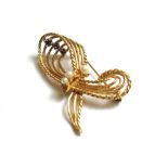 A gold, sapphire and cultured pearl set brooch in a scrolling wirework design,