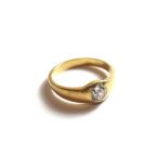 A gold and diamond set single stone ring, gypsy set with a cushion shaped diamond, ring size Q.