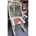A 20th century distressed white painted Laura Ashley rocking chair.