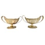 A pair of George III silver twin handled sauce tureens, bearing the mark of Henry Chawner,