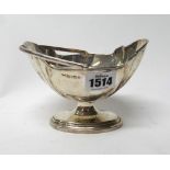 A silver cream pail, of shaped oval form, with a swingover handle, on an oval foot, Birmingham 1911,