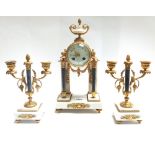 A Louis XVI style ormolu and white marble clock and garniture,