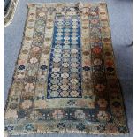 A Caucasian rug, the indigo field filled with single flowerheads, a brown bracket and cross border,