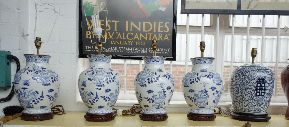 A set of four modern Chinese style pottery table lamps decorated with blue flowers against a white - Image 3 of 3