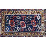 A Karagashli Kuba rug, Caucasian, the dark indigo field with three madder angled flowerheads,