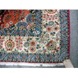 A Tabriz carpet, Persian, the burgundy field with an orange medallion, matching spandrels,