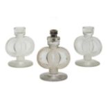 Three Lalique candlesticks 'St James' design, No 2126, designed 1935, one converted to a table lamp,