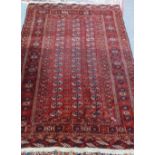 A Tekke Turkman rug, the madder field with three columns of seventeen guls, supporting bee motifs,