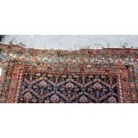 A Fereghan carpet, Persian, the indigo field with rows of plants, with serrated leaves,