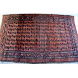 A Beluchistan rug, the madder field with rows of simple flowerheads, a stepped motif border,