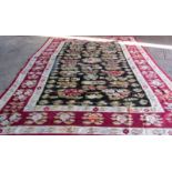 An antique Bessarabian gelim, the charcoal field with floral sprays and leafy plants,