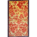 A Senneh mat, the golden field with with all over madder leaves, a minor indigo border, 94cm x 58cm.