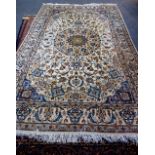 A part silk Esfahan rug; the ivory field with faceted medallion, matching spandrels,
