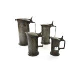 A matched set of four lidded pewter flagons, circa 1800, stamped maker's marks to base,