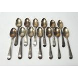 Thirteen George III silver teaspoons, feather edged Old English pattern engraved with crests,