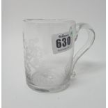 An armorial engraved glass mug, mid-18th century, of cylindrical form with loop handle,