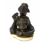 An early Victorian patinated bronze novelty inkwell, modelled and cast as a lady in period dress,