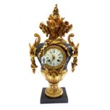 A Continental gilt and patinated bronze mantel clock, 20th century, of two handled urn form,