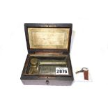 A miniature walnut cased music box, late 19th century, playing 6 airs, 12.5cm wide (key).