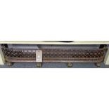 A Victorian steel and brass mounted fire curb with pierced frieze and four lions paw feet,