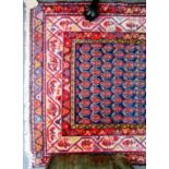 A North West Persian runner, woven with multiple boteh on an indigo field, within multiple borders,