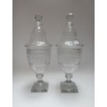 A pair of cut glass urns and domed covers, 19th century,