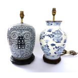 A set of four modern Chinese style pottery table lamps decorated with blue flowers against a white
