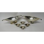 A pair of silver twin handled boat shaped centrepiece bowls, each on an oval foot,