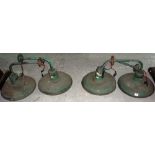 A set of four early 20th century green painted industrial wall mounted lights.