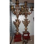 A pair of gilt metal five branch candelabra of 18th century style, each on a rouge marble base,