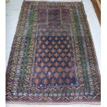 A Baluchistan prayer rug, the indigo mihrab with rows of motifs, various borders, 150cm x 89cm.