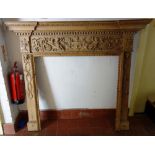 A late 19th century carved pine fire surround of 18th century design, 168cm wide x 144cm high,