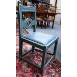 A set of twelve green painted Gothic Revival dining chairs with pierced quatrafoil back and square