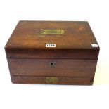 A Victorian rosewood toilet box with fitted interior and sprung lower drawer, 31cm wide.