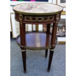 A Louis XVI style marble topped gilt metal mounted mahogany oval two tier gueridon,