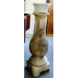 An 18th century carved stone baluster column on square base, 114cm high.