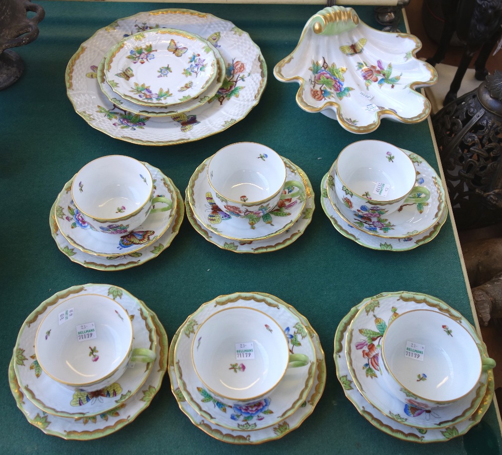 A Herend porcelain part tea service decorated with butterflies against a gilt green ground,