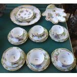 A Herend porcelain part tea service decorated with butterflies against a gilt green ground,